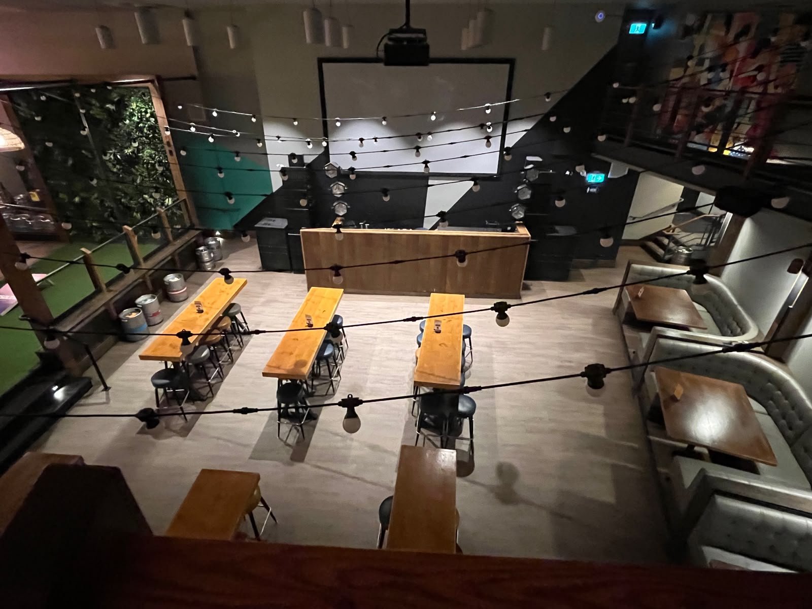 Beer hall with projection screen and string lights